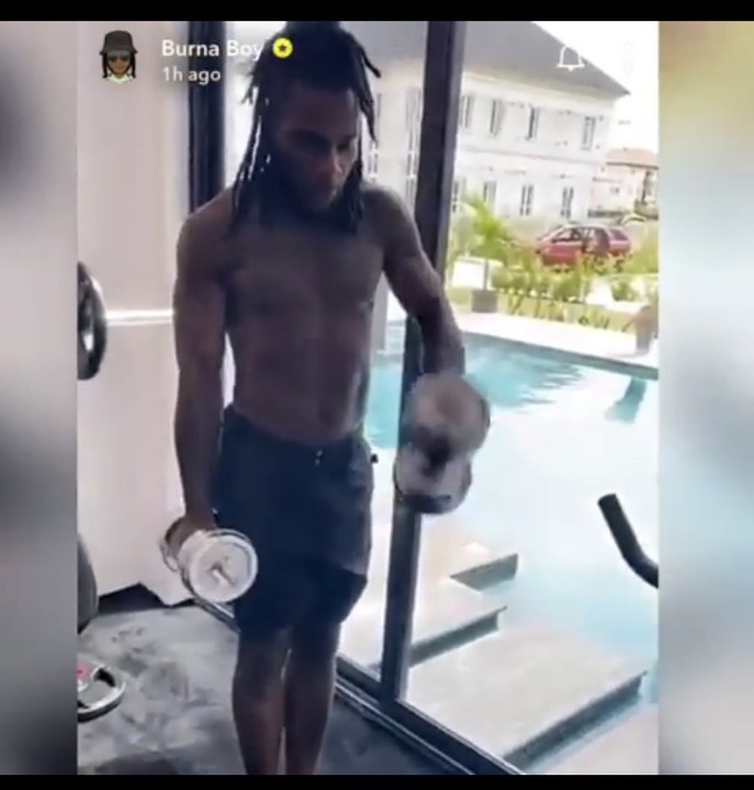 Burna Boy flaunts his cars as he works out in his house (Video)