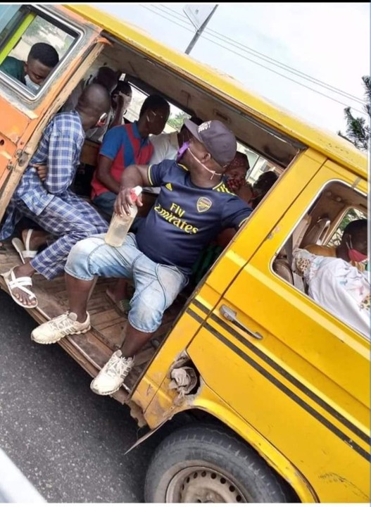 Conductor sanitizes passengers before entering bus (photo)