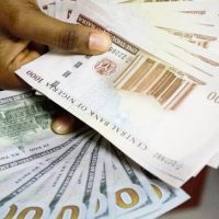 Naira gains N61.38 against dollar at official market
